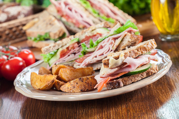 Sandwiches with ham, cheese, tomatoes, lettuce and cucumber