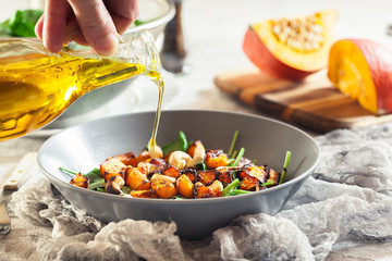 Roasted pumpkin salad with spinach and nuts
