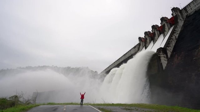 Traveler with a large dam gate. Dam with floodgate, Spillway on the Khun Dan Prakan Chon Dam in thailand.