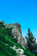 Beautiful alpine high mountains peak, blue sky background. Amazing Mountain hiking paradise landscape, summertime.