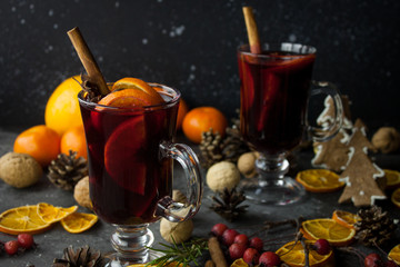 milled Hot wine with Christmas decorations background. Holiday dark photo.