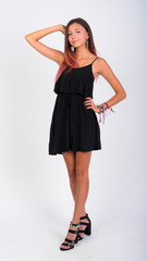 Full body shot of young beautiful woman wearing black dress