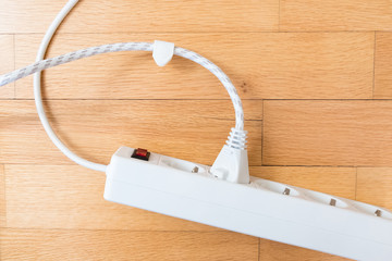 Iron plug and extender on a wooden background