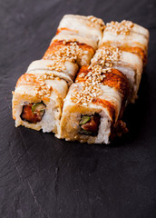 Unagi sushi roll on black slate board