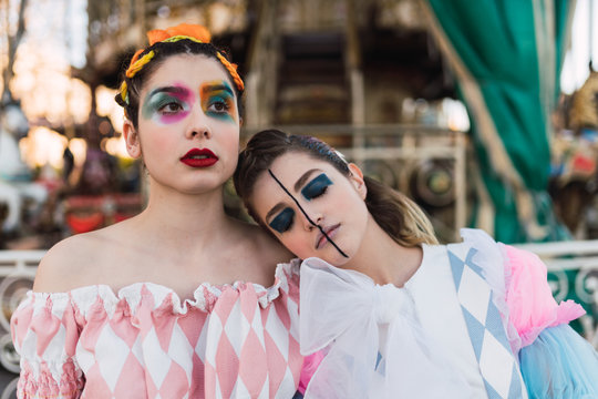 Street performers embracing near carousel