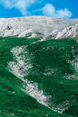 Beautiful alpine high mountains peaks, blue sky background, summertime. Hiking trail through the...