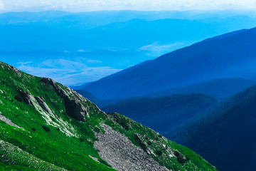 Beautiful alpine high mountains peaks, blue sky background, summertime. Hiking trail through the...