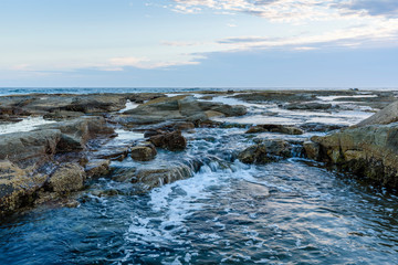 landscape with sea, rocks and blue sky with clouds in Australia