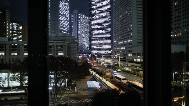 Modern skyscrapers view from elevator going up in the night