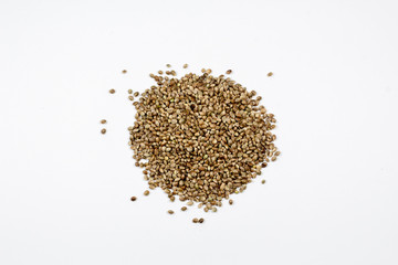Organic whole hemp seeds on a white background