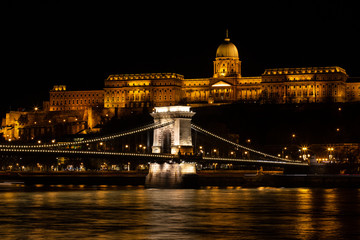 Fototapeta premium Budapest, Hungary - December 08, 2018: Hungarian landmarks, Chain Bridge, Royal Palace and Danube river in Budapest at night. Photo Image