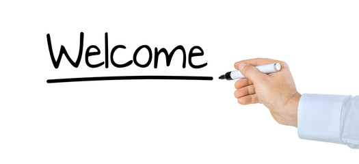 Hand with pen writing Welcome