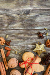 Ginger cookies on a wooden table with spices. Gingerbread men. The symbol of Christmas. Free space for your project.