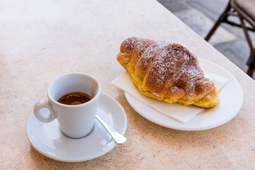 Coffee and croissant with dark chocolate