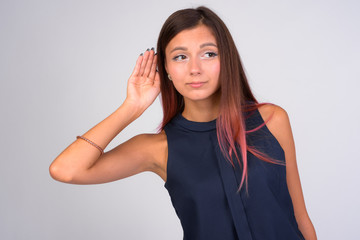 Portrait of young businesswoman thinking while listening