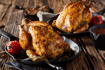 Two poussin or spring chickens on skillets