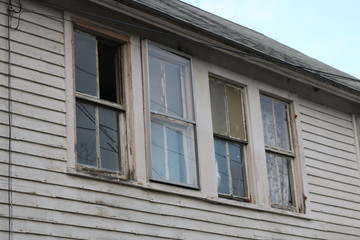 Fototapeta na wymiar Old abandoned wooden weathered abandoned New England farmhouse 