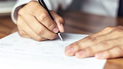 Naklejka premium Businessman signing a document in office