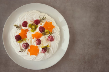 Dessert Pavlova. Cake with whipped cream and fresh berries.