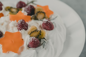 Dessert Pavlova. Cake with whipped cream and fresh berries.