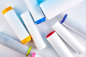 Water filters. Carbon cartridges on a white background. Household filtration system.