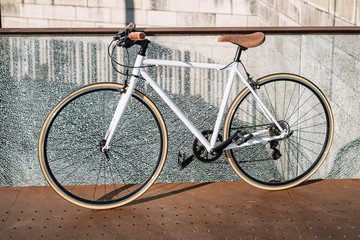 City bicycle fixed gear on broken glass wall