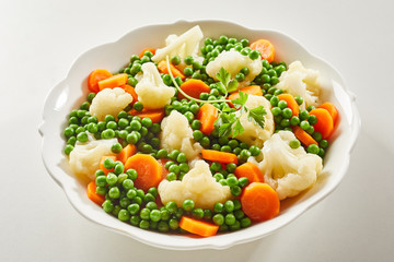 Mixed steamed young vegetables served as a side