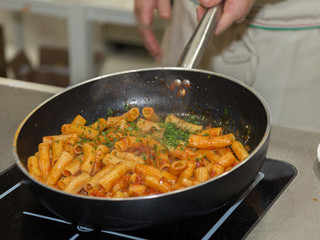 Cooking Italian Pasta inside Saucepan: Chef at Work in the Kitchen