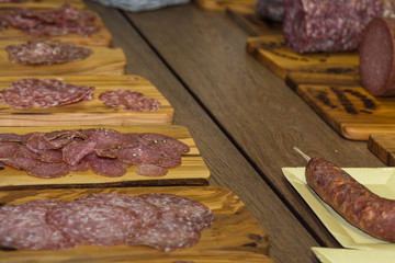 Various Types of Italian Sliced Salami on Wooden Chopping Boards