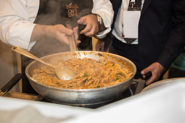 Cooking Italian Pasta inside Saucepan: Chef at Work in the Kitchen