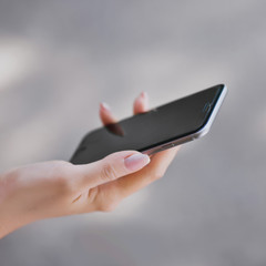 white smartphone in female hands