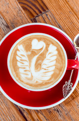 Red cup with cappuccino.