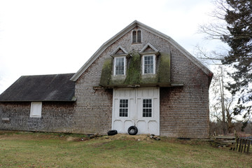 Old weathered rustic wooden barn on historic New England farm
