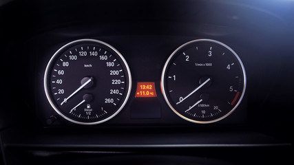 Modern car dashboard. Tachometer, fuel level and icons on the panel screen.