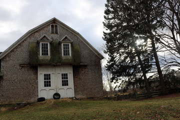 Old weathered rustic wooden barn on historic New England farm