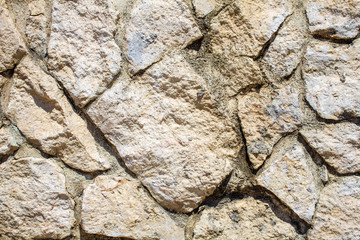 White Stoned Wall in Uneven Cut for Background. Closeup View of Chalky Dry Rock Formation in Abstract. Crazy Pattern of Rock Paved Structure Art of Masonry