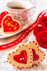 Homemade Valentines day heart cookies red roses on white rustic background