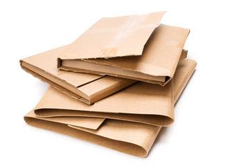 Stack of cardboard book mailers on white background.