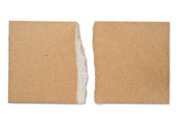 Pieces of torn cardboard on white background.