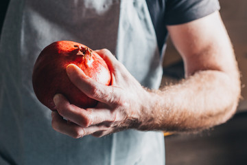 Preparing a ripe large juicy pomegranate for extracting juice - a healthy diet