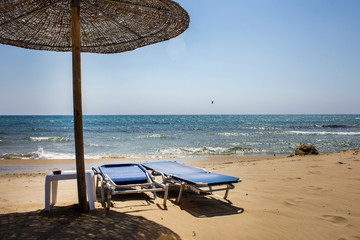 Wooden Umbrella Screening the Sunlight and Heat. Folded and Unfolded Adjustable Beach Recliner...