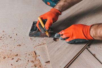 The master marks out the cut with a pencil and square - floating floor