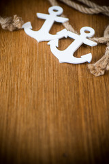 white decorative anchor on a wooden background