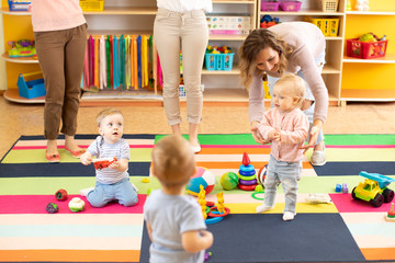 nursery kids or children playing in kindergarten room