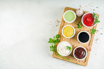 Set of classic sauces on white stone concrete stone background.