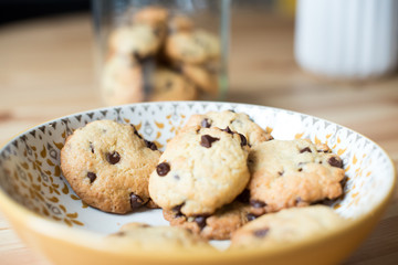 Homemade cookies on a plate with jar