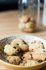 Homemade cookies on a plate with jar