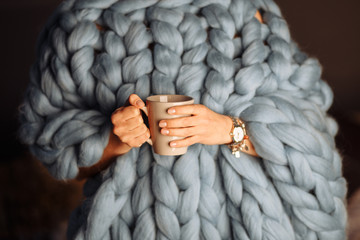 blue knitted blanket with cup