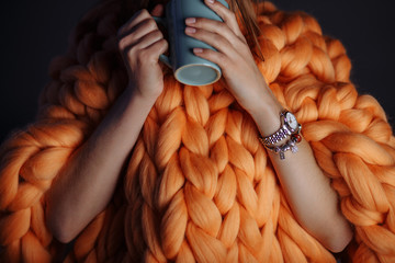 orange knitted blanket with cup