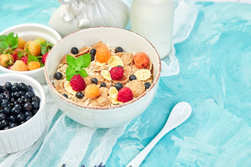 Healthy vegetarian breakfast. Oatmeal, granola with raspberries